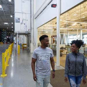 Two people walking in a facotry