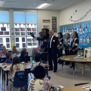 LA Kings Alumn and radio analyst Daryl Evans, the LA Kings Ice Crew and mascot Bailey greets students in Los Angeles, CA for Read Across America Day.