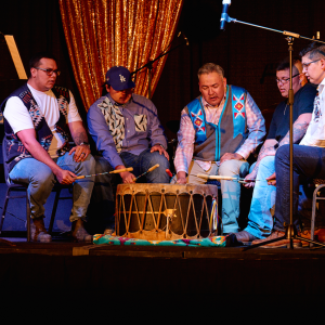 People drumming onstage