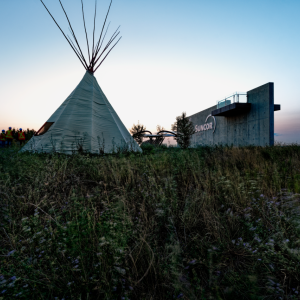 Teepee in front of sunset sky
