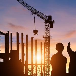Silhouette of construction workers at sunset