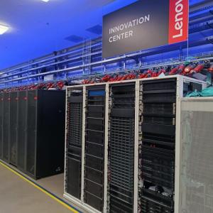 Row of tall servers and tech devices. A lenovo Innovation Center banner overhead.