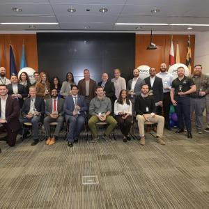 Large group photo of people holding an award