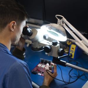 Person working on technology under bright light