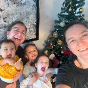 Cécile Vivares shown with her wife and three children in front of the family Christmas tree.