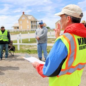 AEG employees and fans receive instruction at the Fort Morgan clean-up.