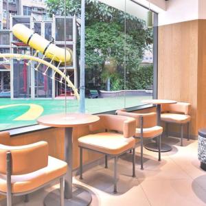 Inside of a McDonald’s restaurant with a window looking out on to an outdoor play area 
