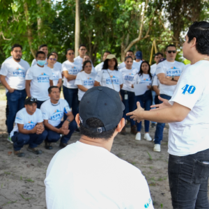 Gildan employees featuring "Respect in Action" and 40th anniversary t-shirts, standing in a circle during a volunteering activity