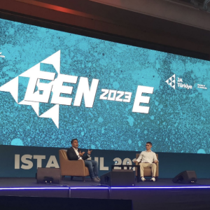 Two people on stage having a discussion at the GEN-E European Entrepreneurship Festival,