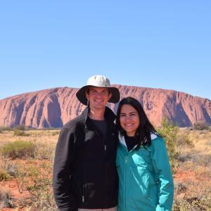 two people posing in front of landscape