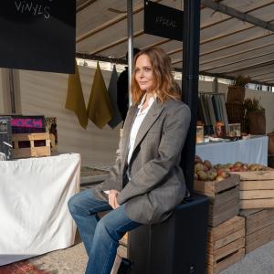 Designer Stella McCartney shown seated on a JBL Speaker in her Sustainable Market.