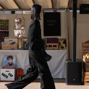 Model shown wearing a black pantsuit in Stella McCartney's Sustainable Market.