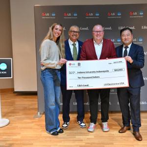 WNBA player Lexie Hull, far left, Daniel Gillison, CEO of the National Alliance on Mental Illness (NAMI), left, Luke Bosso, athletic director of IU Indianapolis, right, and Don Kwack, CEO LG Electronics North America, far right, pose for a photo after LG and NAMI donated $10,000 to the university to help with student athlete mental health on Friday, April 3, 2026, in Indianapolis, Indiana.