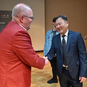 Luke Bosso, athletics director at IU Indianapolis, left, shakes hands with Don Kwack, CEO of LG Electronics North America on Friday, April 3, 2026, in Indianapolis, Indiana.