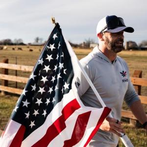 Jason Wood carrying flag