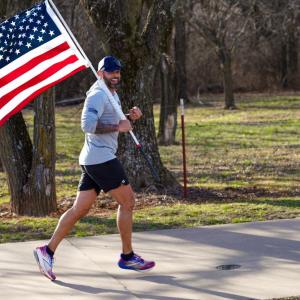 Jason Wood running with flag