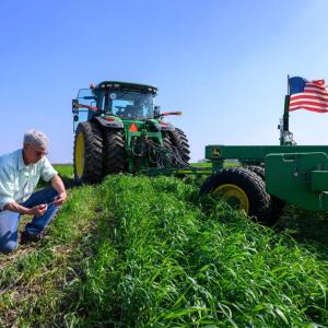 Tractor in field under blue sky