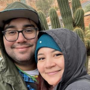 Jacob Rodriguez and his wife in front of a cactus.