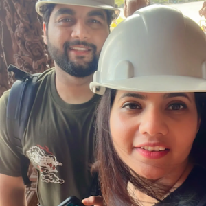 Jai shown with his wife and both are wearing hardhats.