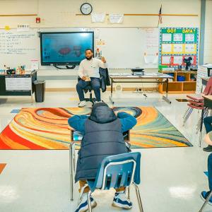 Jalen Roddey sat on a chair talking to a class of students 