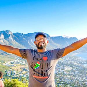 Jalen Roddey stood with his arms out in front of a mountain 