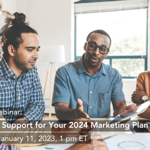 A professional team sits around an indoor table, listening to their colleague speak. Text overlay shares information on Taproot's free webinar on marketing pro bono.
