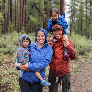 Jenny Luong shown with her husband and children hiking.