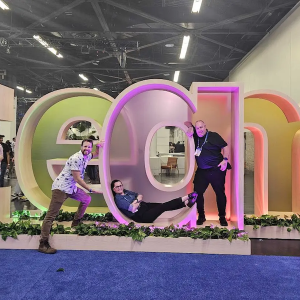Jess and team members in front of a "Team" sculpture.