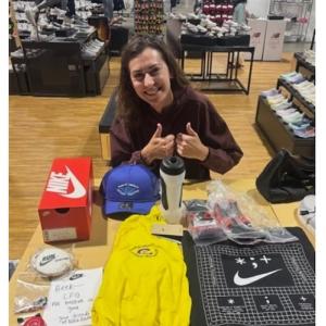 Nike’s Jo Dearman with Sabik’s marathon care package, including his extra prosthetic attachments.