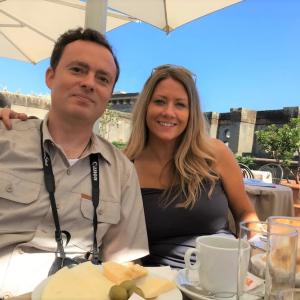 Joe Styler and his wife having breakfast on the deck of a building.