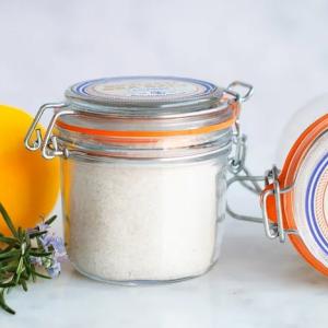 Sicilian Sea Salt shown in it's container and with lemons.