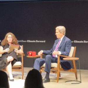 John Kerry and interviewer on stage