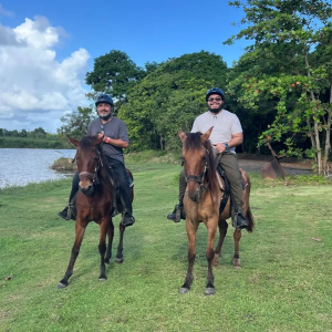 Jonathan with a friend riding horses.