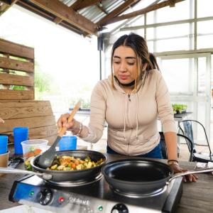 A person cooking at Jones Valley Teaching Farm