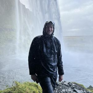 Josh Casemier stood in front of a waterfall 