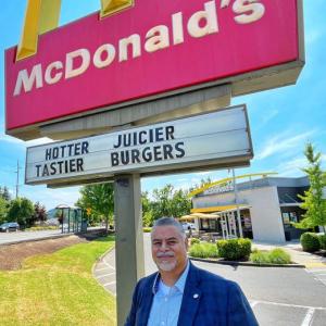 Juan Marquez outside by a McDonalds restaurant sign.