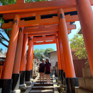 Julia and a companion at an Asian temple.