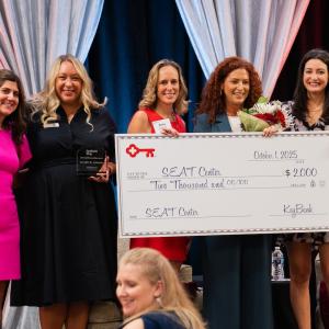 Key4Women Committee members present that annual Achieve Award to SEAT CEO and Founder Jennifer Lawrence. SEAT also received a $2,000 donation.  