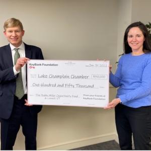 Photo caption: KeyBank Vermont Market President Don Baker presents a grant for $150,000 to Lake Champlain Chamber President Cathy Davis to support the Bobby Miller Opportunity Fund and LaunchVT. Photo credit: KeyBank 