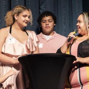 Move To PROSPER participants share their stories from the podium. Photo Credit: Steve Rose.