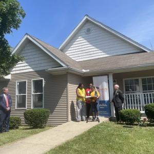 Photo: Representatives from KeyBank, NeighborWorks and The Fair Housing Center welcome Cynthia and Larry Robinson to their new home in West Toledo.