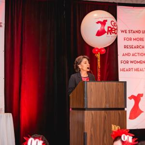Kathryn Collins speaking at a podium.
