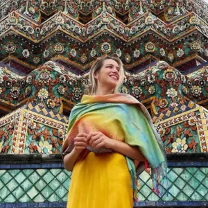 Karla Huerta in front of a colorful building.