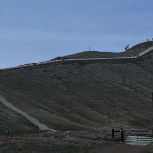 Panoramic view of the valley, a winding road up to a large, brightly lit star.