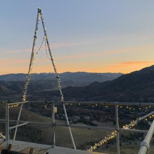 A panoramic view of a valley at sunset. 