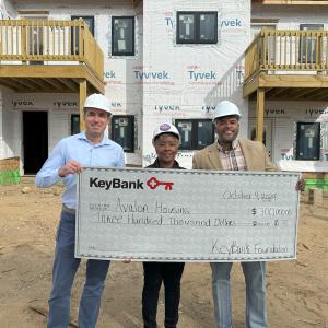 KeyBank and Avalon Housing representatives shown with a $300,000 grant check.
