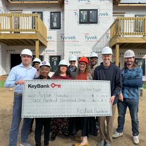 KeyBank and Avalon Housing representatives shown with a $300,000 grant check.