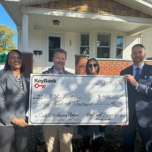 KeyBank and LISC Toledo leadership shown with a $400,000 grant check.