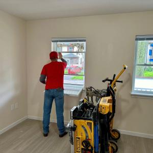 Habitat for Humanity team member installing windows.