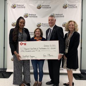 KeyBank Foundation members present a check to the Northeastern Food Bank.
